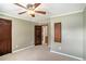 Bedroom with neutral-colored walls, carpet, ceiling fan, and dark wood trim at 95 Oak Grove Cir, Mcdonough, GA 30253