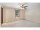 Spacious carpeted bedroom with a ceiling fan and natural light from a window at 95 Oak Grove Cir, Mcdonough, GA 30253