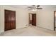 Bedroom featuring carpet, ceiling fan, and a closet with dark wood doors at 95 Oak Grove Cir, Mcdonough, GA 30253