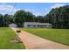 Ranch-style home with a long driveway, a detached garage, and a well-maintained front lawn at 95 Oak Grove Cir, Mcdonough, GA 30253