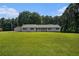Inviting ranch-style home with a detached garage on a manicured lawn and mature trees at 95 Oak Grove Cir, Mcdonough, GA 30253