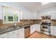 Well-lit kitchen with stainless steel appliances, granite countertops, and a view to the backyard at 95 Oak Grove Cir, Mcdonough, GA 30253