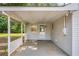Covered patio featuring concrete flooring, white railing and side door overlooking a grassy backyard at 95 Oak Grove Cir, Mcdonough, GA 30253