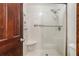 Shower with a glass door, grab bar, and built-in seat, offering accessibility and convenience at 95 Oak Grove Cir, Mcdonough, GA 30253