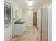 Functional utility room with ample storage, sink, and tile flooring offers convenience and practicality at 95 Oak Grove Cir, Mcdonough, GA 30253