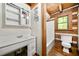 Bathroom with a white vanity, matching mirror, toilet, and tub at 1975 Mack Rd, Douglasville, GA 30135