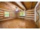 Bedroom with wooden floors, ceiling, and walls, with two windows and a door at 1975 Mack Rd, Douglasville, GA 30135