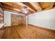 Bedroom with wooden floors, white walls, rustic door, and ceiling fan at 1975 Mack Rd, Douglasville, GA 30135