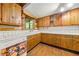 Rustic kitchen featuring wood cabinetry, white tiled countertops, and vintage appliances and wood floors at 1975 Mack Rd, Douglasville, GA 30135