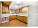 Vintage kitchen with wood cabinets, white tiled countertops, and appliances and a window overlooking the outdoors at 1975 Mack Rd, Douglasville, GA 30135