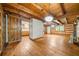 Open living space with hardwood floors, beam ceilings, access to other room with barn door and stone fireplace at 1975 Mack Rd, Douglasville, GA 30135
