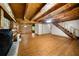 Inviting living room with wood floors, exposed beam ceilings, stone fireplace and a staircase leading to the upper level at 1975 Mack Rd, Douglasville, GA 30135
