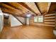 Bright living area featuring wood floors, rustic wood beam ceiling, staircase, and windows providing scenic views at 1975 Mack Rd, Douglasville, GA 30135
