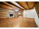 Spacious living room showcasing wood floors, exposed beam ceilings, a cozy stone fireplace and natural light at 1975 Mack Rd, Douglasville, GA 30135