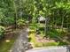 Wooded property featuring a charming log cabin set back from the road at 1975 Mack Rd, Douglasville, GA 30135
