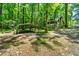 An exterior view showcasing the home and parking located in the forest at 1975 Mack Rd, Douglasville, GA 30135