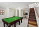 Finished basement featuring a pool table and stairs leading to the upper level at 240 W Lake Nw Dr, Atlanta, GA 30314