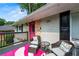 Inviting covered front porch with seating area, plants, and stylish decorations at 240 W Lake Nw Dr, Atlanta, GA 30314