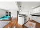 Inviting living room with hardwood floors, a kitchen island, and modern appliances at 240 W Lake Nw Dr, Atlanta, GA 30314