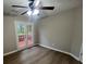 Bedroom with ceiling fan and double doors that lead to the outside and wood-look flooring at 5961 Sherwood Trce, Stonecrest, GA 30038