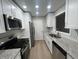 Modern kitchen featuring stainless steel appliances, granite counters, and white cabinets at 5961 Sherwood Trce, Stonecrest, GA 30038