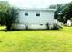 A well-maintained backyard featuring a cozy deck with stairs and lush lawn at 6471 Ansley Blvd, Lithia Springs, GA 30122