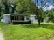 Charming single-story home with a covered porch and mature trees in a lush, green yard at 6471 Ansley Blvd, Lithia Springs, GA 30122