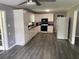 Well-lit kitchen with ample storage, sleek appliances, and vinyl floors at 6471 Ansley Blvd, Lithia Springs, GA 30122