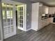 Updated kitchen with white cabinets, stylish vinyl flooring, and access to a bright sunroom at 6471 Ansley Blvd, Lithia Springs, GA 30122