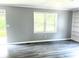 Bright living room featuring large windows, vinyl floors, and neutral wall color at 6471 Ansley Blvd, Lithia Springs, GA 30122