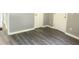 A living room with gray walls, white trim, and dark-colored wood flooring at 6471 Ansley Blvd, Lithia Springs, GA 30122