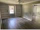 Inviting living room featuring built-in bookshelves, modern flooring, and ample space for relaxing at 6471 Ansley Blvd, Lithia Springs, GA 30122