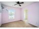 Comfortable bedroom with light pink walls, window, and a ceiling fan at 157 Spur Ln, Hiram, GA 30141