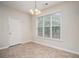 Cozy dining area featuring tile flooring, a modern chandelier, and a large window with nature views at 157 Spur Ln, Hiram, GA 30141