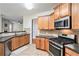 Well-equipped kitchen featuring wood cabinets, stainless steel appliances, and granite countertops for meal preparation at 157 Spur Ln, Hiram, GA 30141