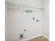 Functional laundry area with a overhead storage rack and tile floor at 157 Spur Ln, Hiram, GA 30141