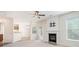 Open-concept living room featuring a fireplace and lots of natural light at 157 Spur Ln, Hiram, GA 30141