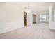 Open-concept living and dining room featuring neutral paint, plush carpet and natural light from a bay window at 157 Spur Ln, Hiram, GA 30141