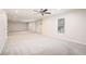Spacious living room featuring plush carpet, neutral walls, and a ceiling fan at 157 Spur Ln, Hiram, GA 30141