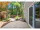 Paver patio surrounded by mulch beds, trees and a partial fence offering a private, fenced outdoor retreat at 1901 Brittania Cir, Woodstock, GA 30188