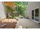 Paver patio surrounded by mulch beds, trees and a partial fence offering a private, fenced outdoor retreat at 1901 Brittania Cir, Woodstock, GA 30188
