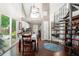 Bright dining area with a view of the kitchen, spiral staircase, and sliding glass doors to the backyard at 1901 Brittania Cir, Woodstock, GA 30188