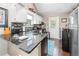 Modern kitchen with granite countertops, stainless steel appliances, white cabinets, and a door to the yard at 1901 Brittania Cir, Woodstock, GA 30188