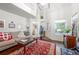 Cozy living room with hardwood floors, neutral walls, large windows, and comfortable seating at 1901 Brittania Cir, Woodstock, GA 30188