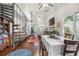 Spacious living area featuring a spiral staircase, fireplace, and dining table, illuminated by natural light at 1901 Brittania Cir, Woodstock, GA 30188