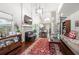 Cozy living room with hardwood floors, a fireplace, large windows, and open access to the kitchen at 1901 Brittania Cir, Woodstock, GA 30188