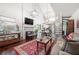 Bright living room with hardwood floors, a fireplace, large windows, and a view of the open staircase at 1901 Brittania Cir, Woodstock, GA 30188