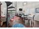 Bright living space with spiral staircase, fireplace, dining area, and hardwood floors at 1901 Brittania Cir, Woodstock, GA 30188