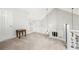 Open loft area with white railing and neutral carpet, creating a versatile living space at 1901 Brittania Cir, Woodstock, GA 30188