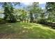 Well-maintained backyard with lush green grass and mature trees at 1971 Hooper St, Decatur, GA 30032